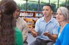 Diverse people having a discussion in a group meeting