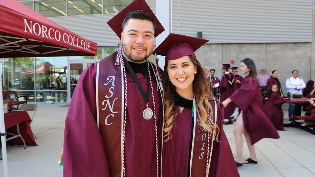 Graduates at Norco College wearing burgundy cap and gown