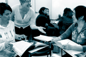 Group of women discussing and reading through books