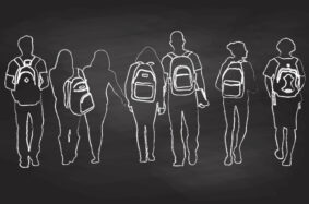 silhouette of students walking with backpacks