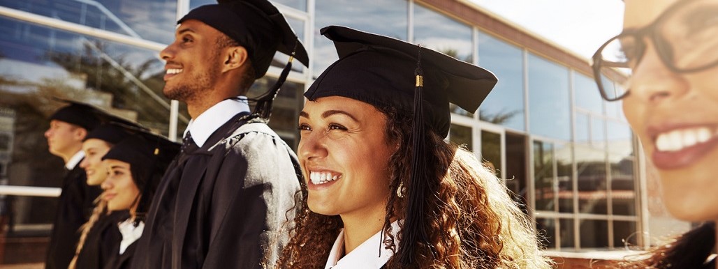 College graduates looking forward and smiling