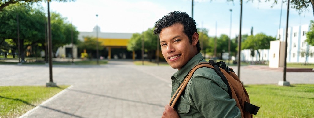 Latino student looking back and smiling