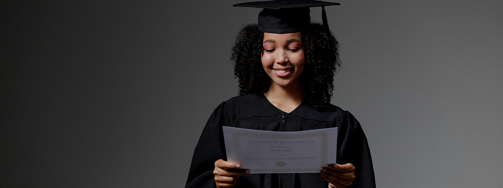 pexels-ron-lach-9829310-cropped Black female graduate holding a certificate